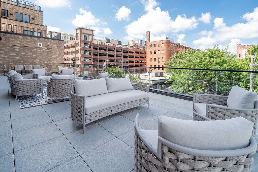 a rooftop patio with a view of the city