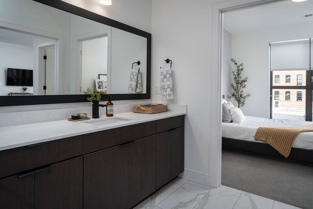 a master bathroom with a large mirror and a sink