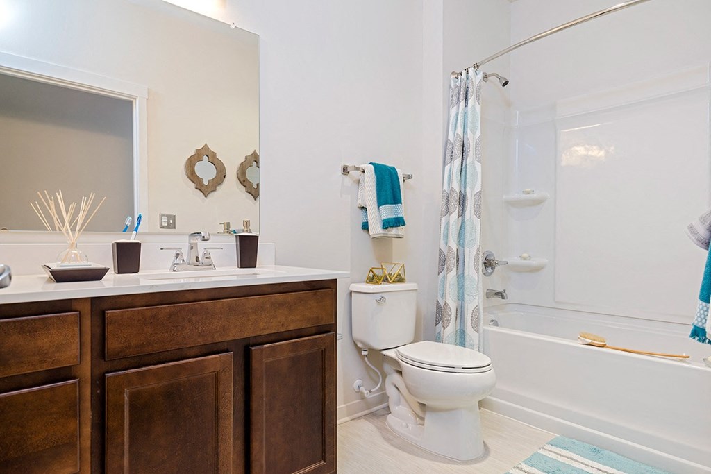 a bathroom with a toilet and a shower and a sink