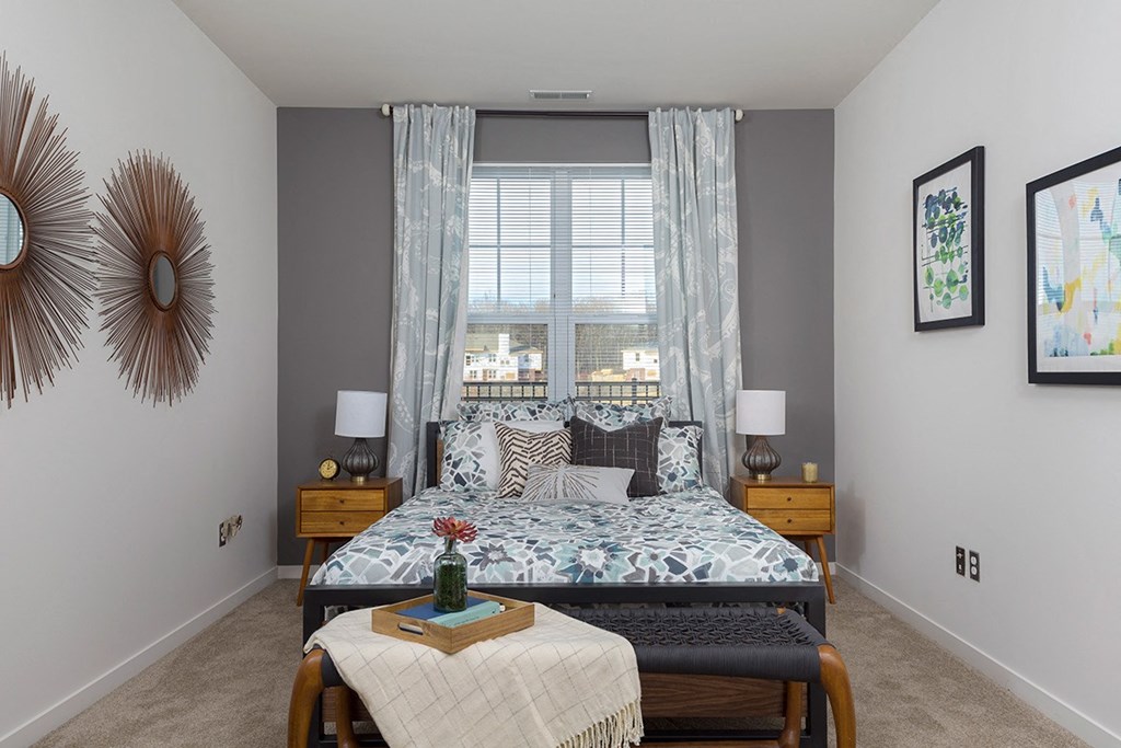 a bedroom with a bed and a window