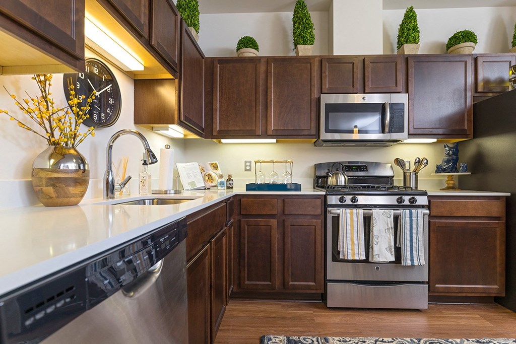 a kitchen with stainless steel appliances and wooden cabinets