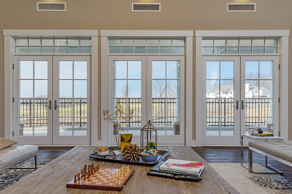 a living room with glass doors and a view of the outdoors