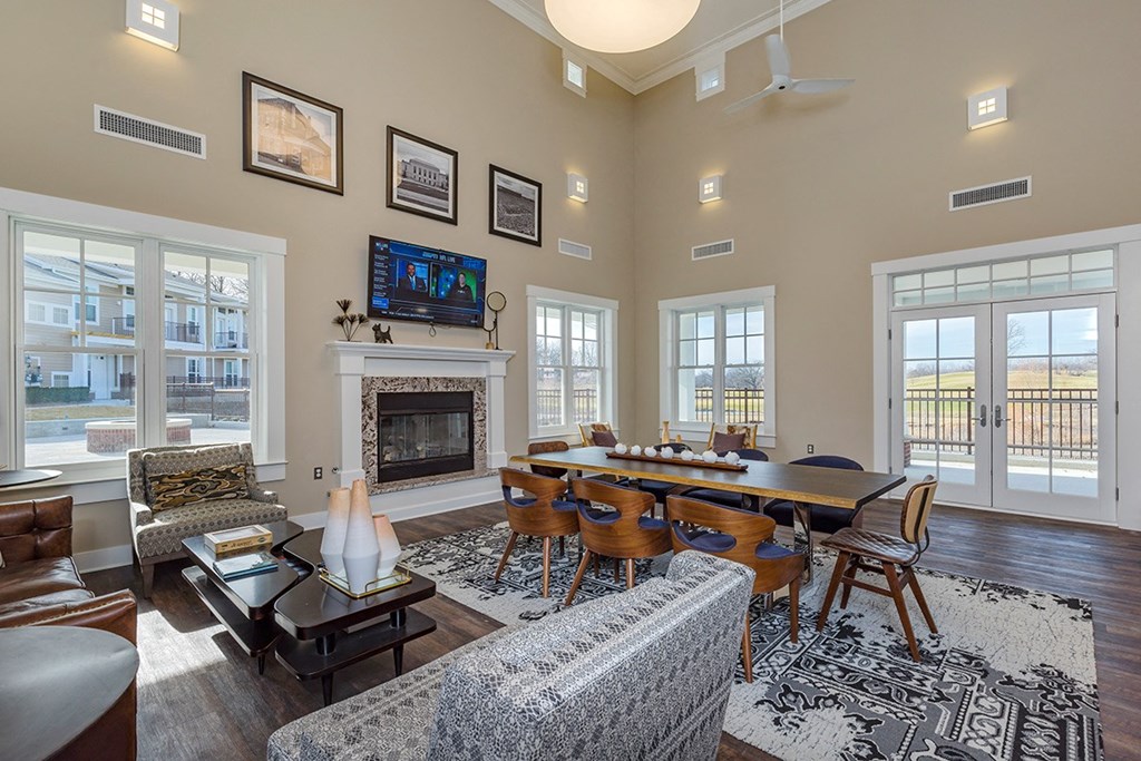 clubhouse with lounge chairs table and fireplace