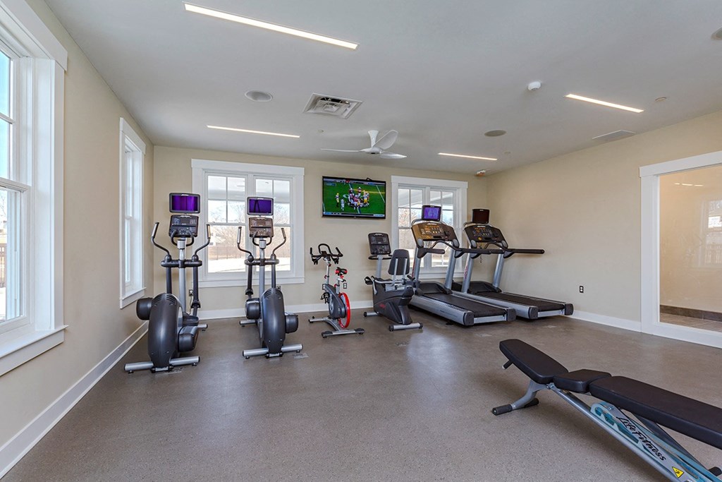 fitness center with elliptical machines and treadmills