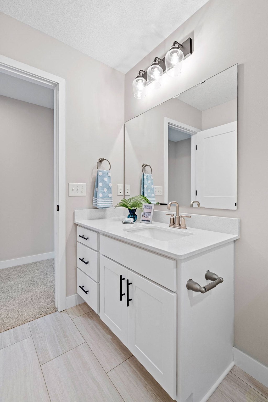 a white bathroom with a sink and a mirror