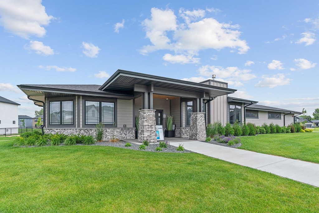 A modern house with a stone pillar in front.