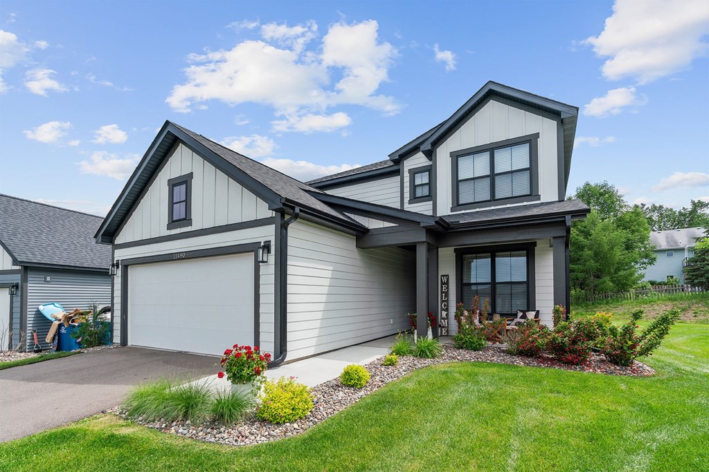 A modern house with a grey exterior and a white garage door.