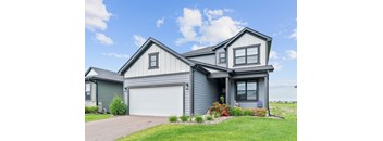 A modern house with a grey exterior and a white garage door.