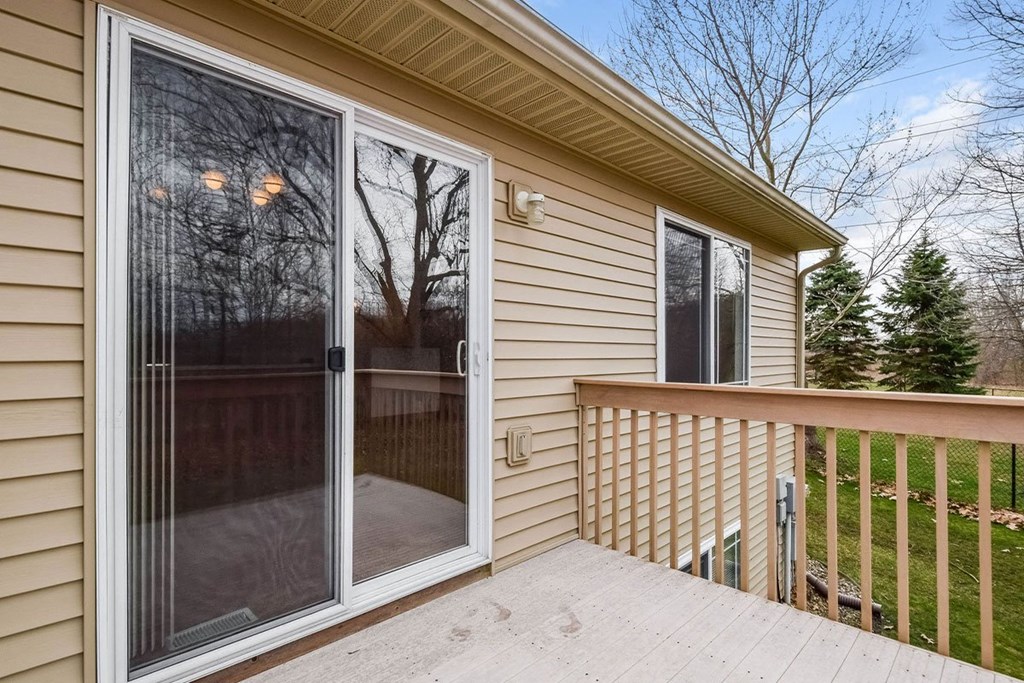 the deck of a home with a sliding glass door