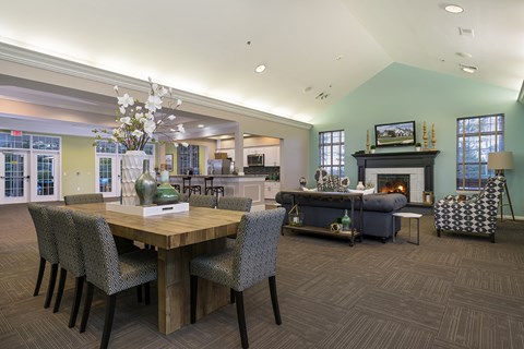 A dining room with a wooden table and chairs.