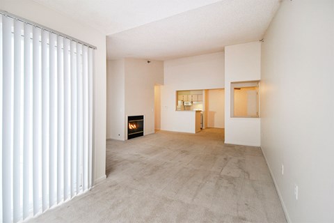 A room with a fireplace and a carpeted floor.