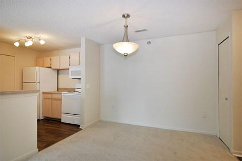 A kitchen with a white fridge and a white dishwasher.