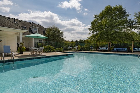 A large swimming pool with a blue tinted water.