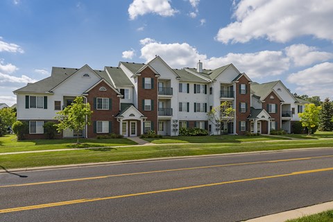 A row of houses with a road in front.