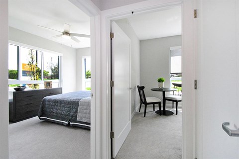 A bedroom with a bed and a chair in it.