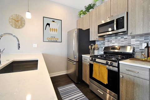 A kitchen with a stove top oven and a fridge.