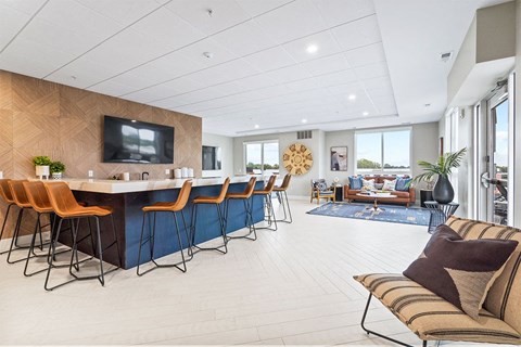 A modern living room with a bar area and a television.