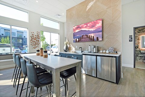 A modern kitchen with a dining table and chairs.