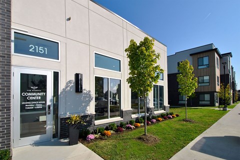 The Community Center is a modern building with a white facade and glass windows.