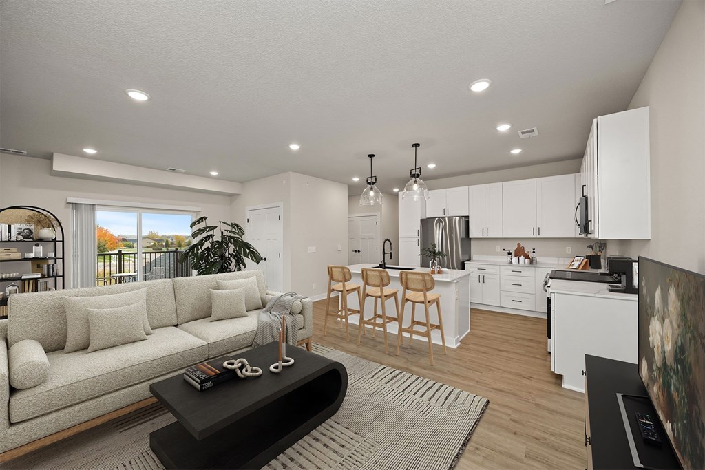 A modern living room with a white sofa and a black coffee table.