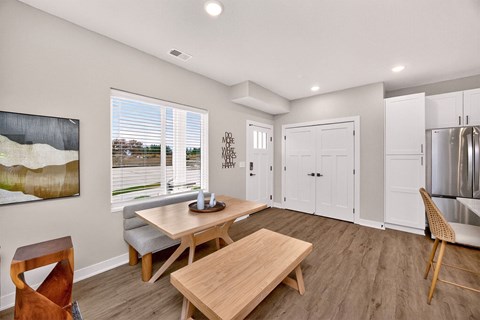 A modern dining room with a wooden table and chairs.