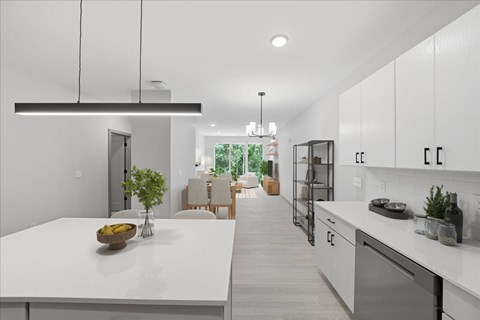 A modern kitchen with white cabinets and a large island.