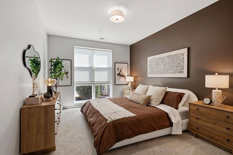 A bedroom with a large bed and a window.
