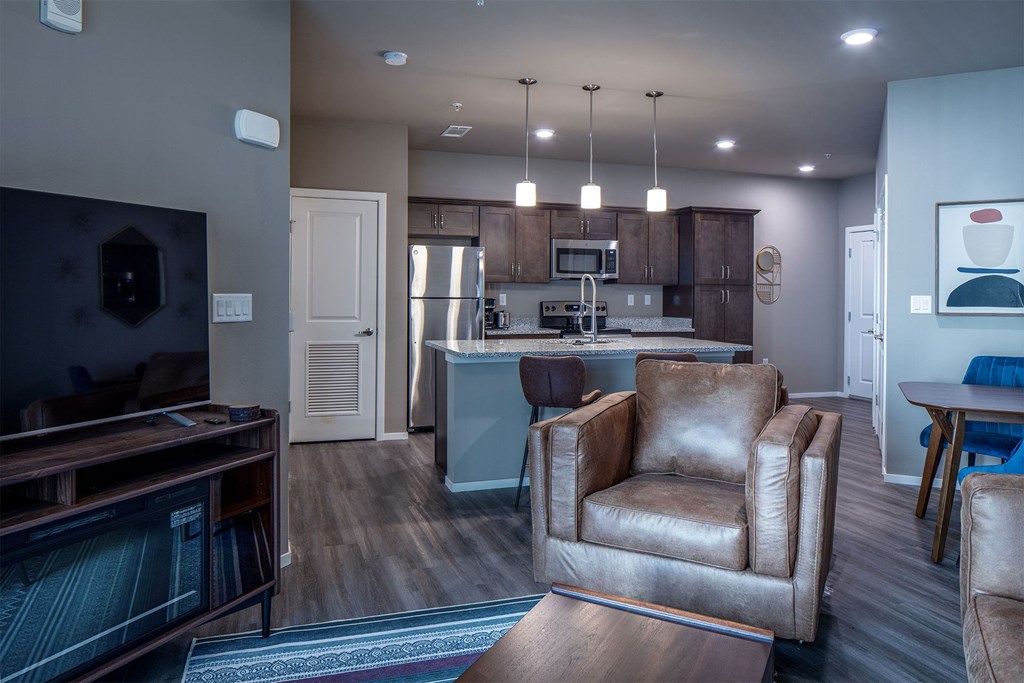 A living room with a brown leather chair and a wooden coffee table.