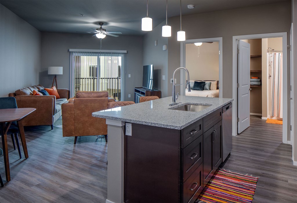 A kitchen with a countertop and a sink is shown.