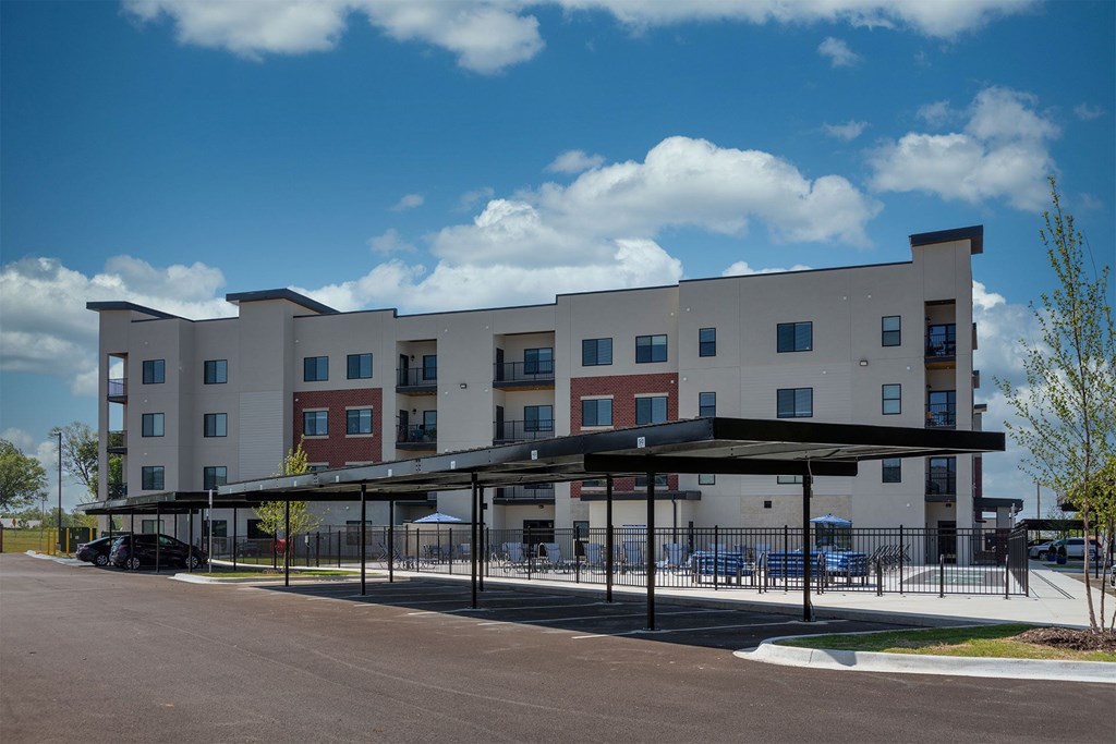 A large building with a parking lot in front.