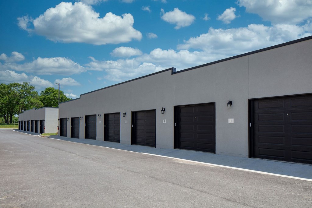 A long building with black garage doors.