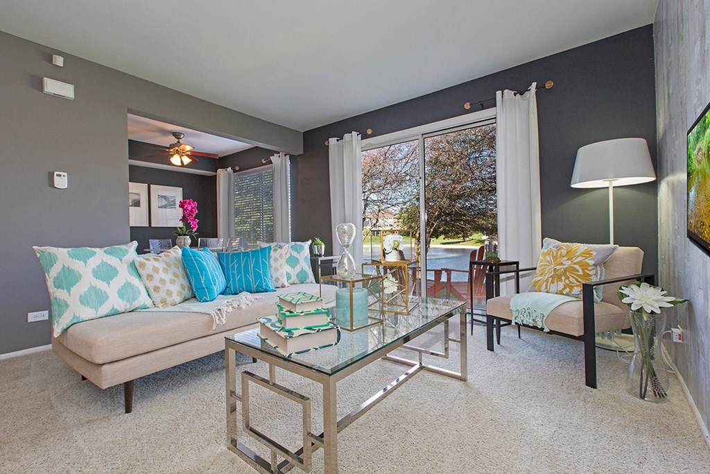 a living room with a couch and a glass table