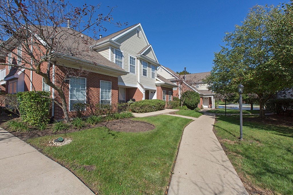 a sidewalk in front of a row of houses