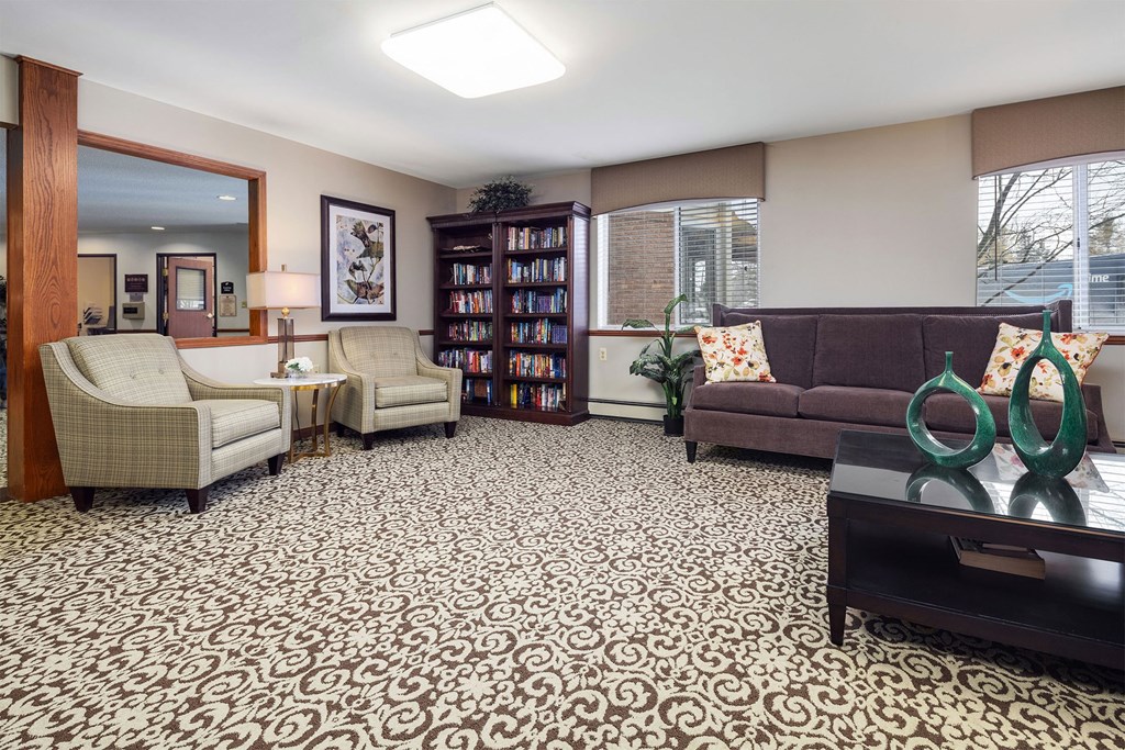 a living room with couches and chairs and a table