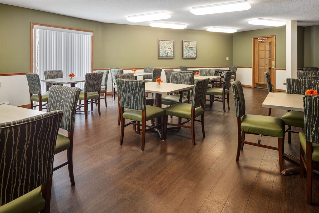a large dining room with tables and chairs and chairs