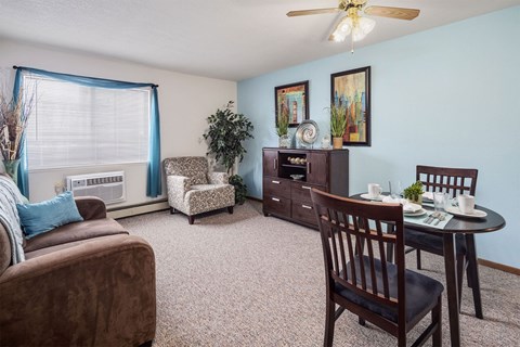 a living room with a couch and a table with chairs