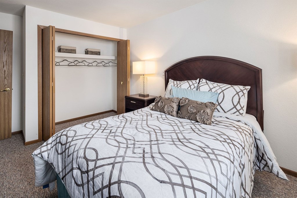 a bedroom with a large bed and a closet