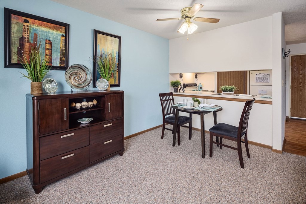a living room with a dining room table and a kitchen