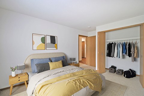 bedroom with bed and nightstand and a wide closet
