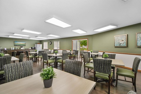 a large dining room with tables and chairs and chairs