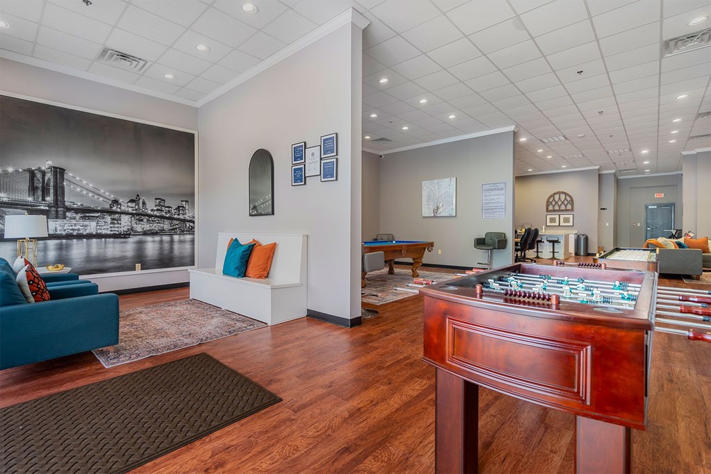 A room with a wooden floor and a large bridge mural on the wall.