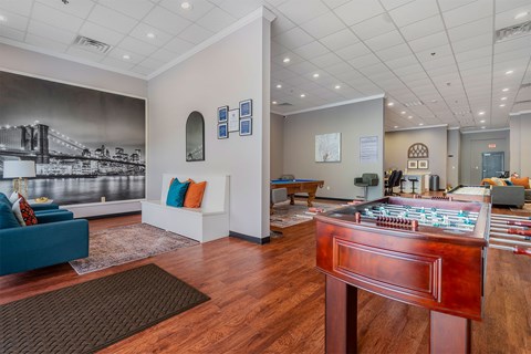 A room with a wooden floor and a large bridge mural on the wall.