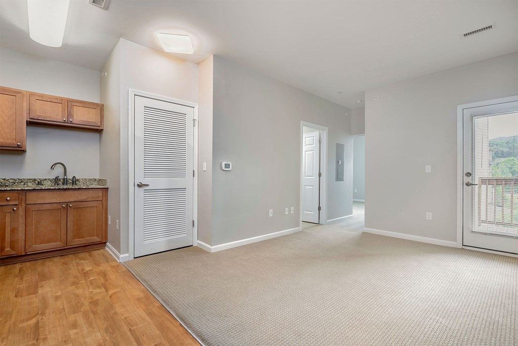 A room with a wooden cabinet and a marble countertop.