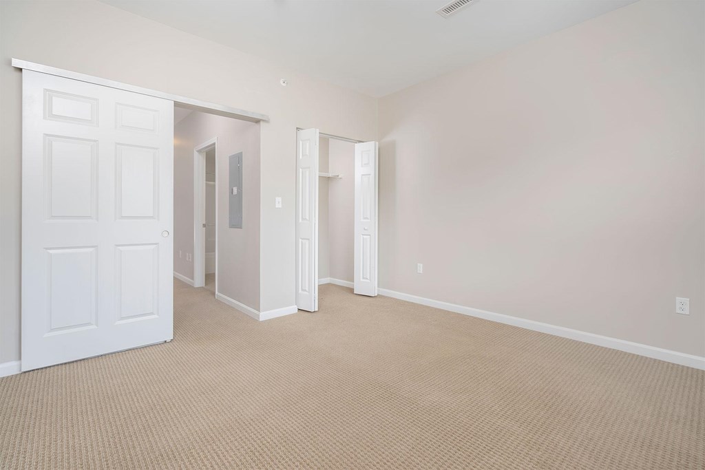 A room with a carpeted floor and white walls.