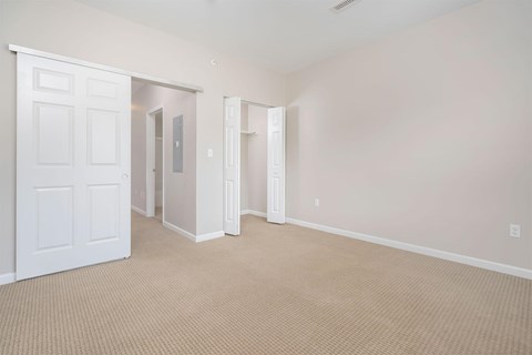 A room with a carpeted floor and white walls.