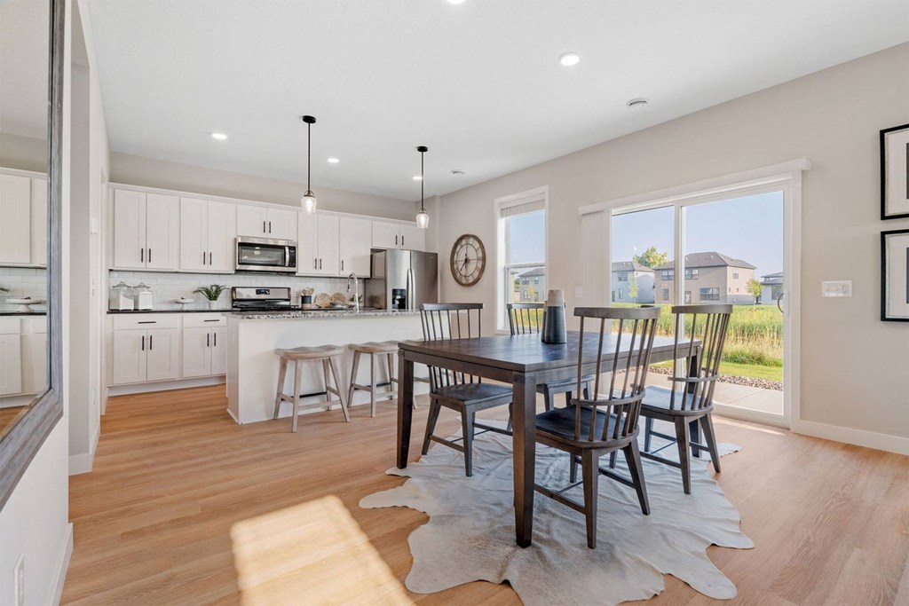 an open kitchen and dining room with a table and chairs