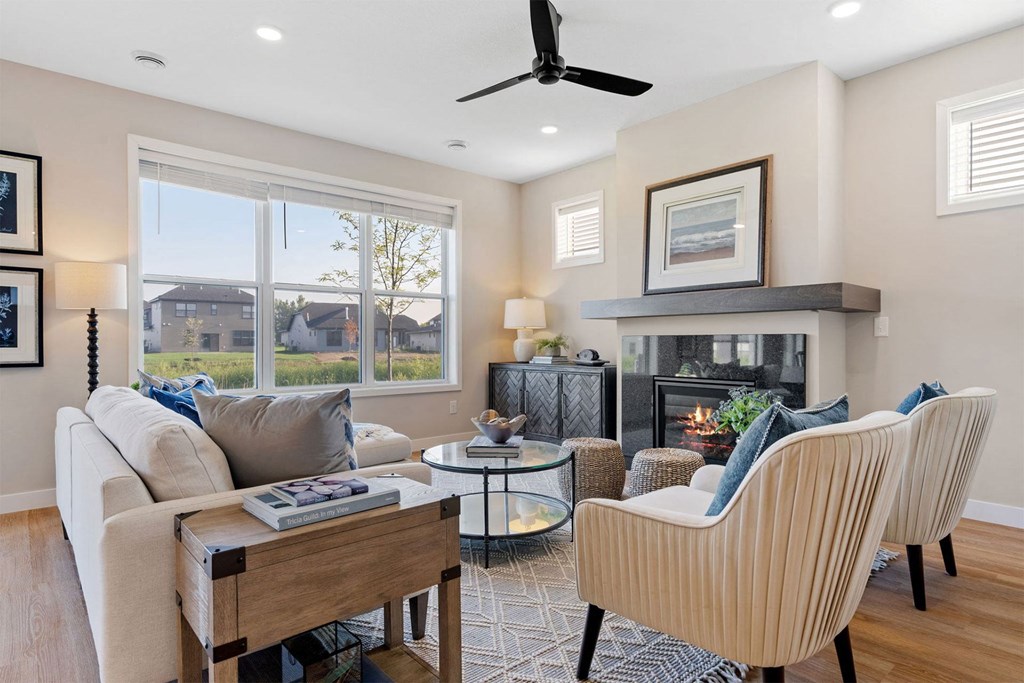 a living room with a couch and chairs and a fireplace