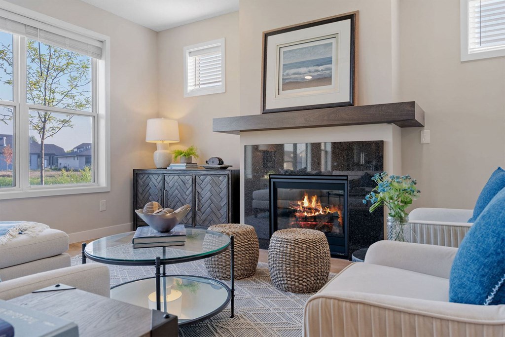 a living room with a fireplace and furniture