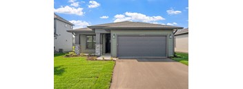 a house with a driveway and a garage door