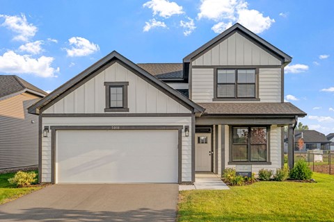 a white and gray house with a garage door